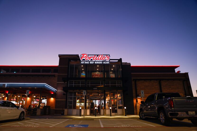 The sun sets behind Portillo’s on its first day open in The Colony on Monday, Jan. 9, 2023.