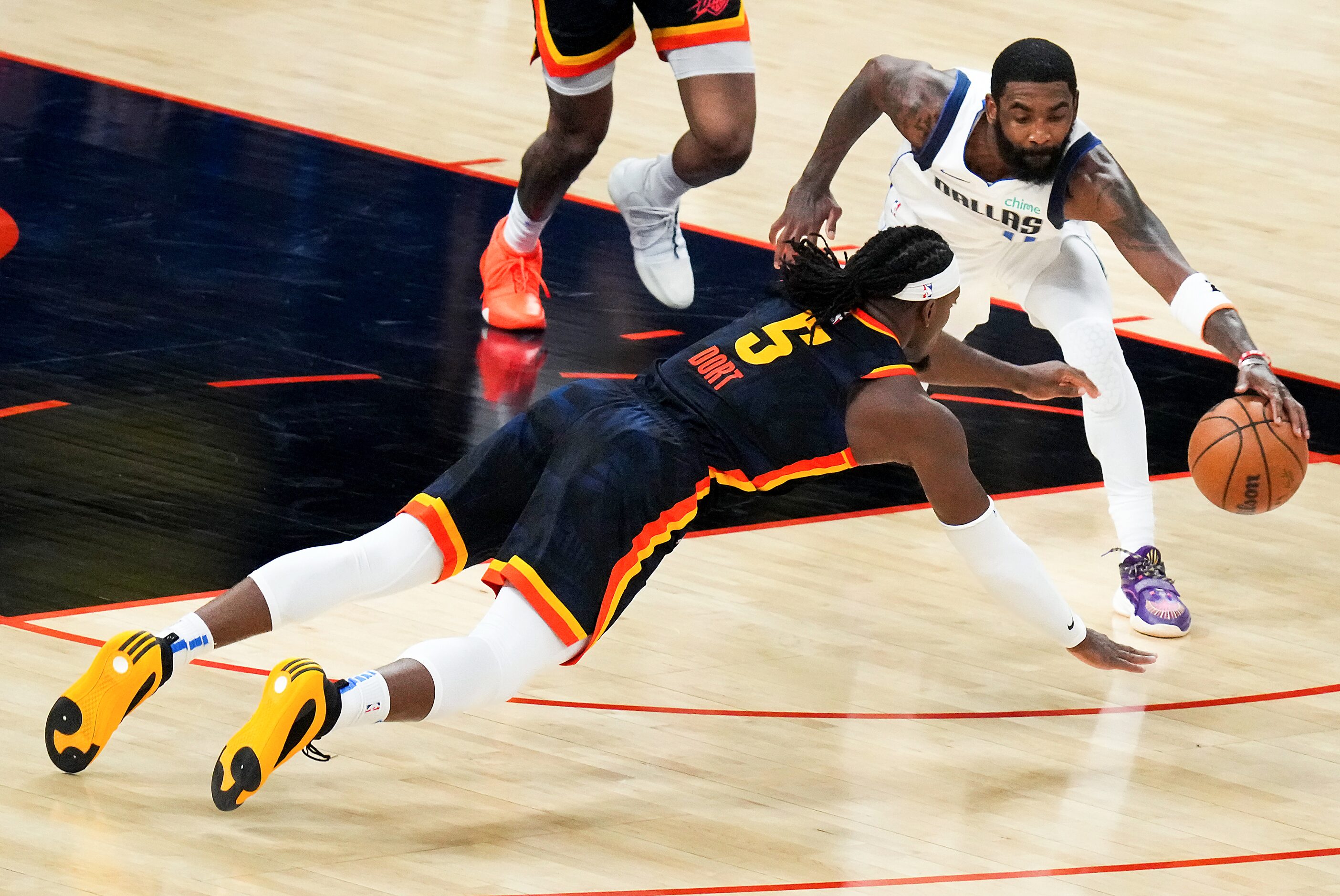 Dallas Mavericks guard Kyrie Irving (11) grabs a loose ball away from Oklahoma City Thunder...