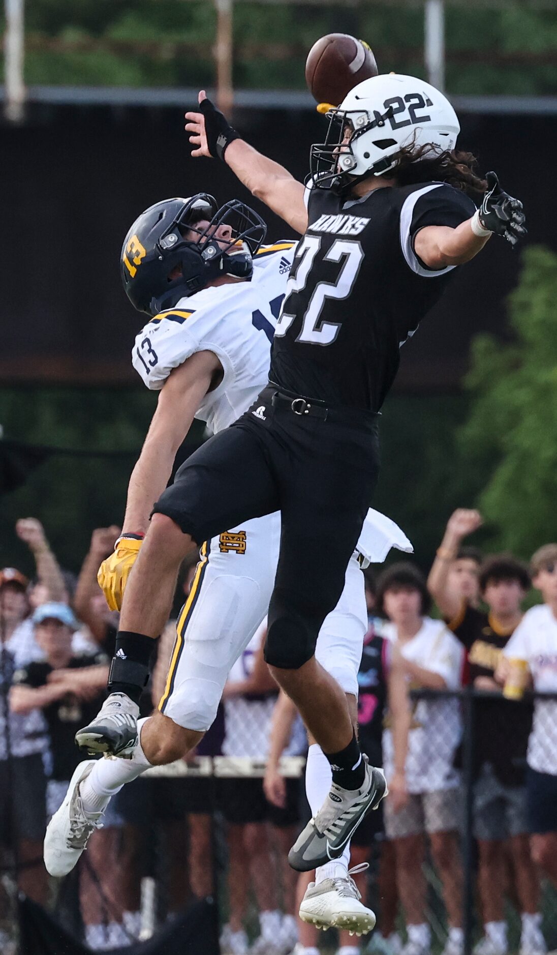 St. Mark's School of Texas Mateu Parker (13) jumps to catch the ball  while defended by...