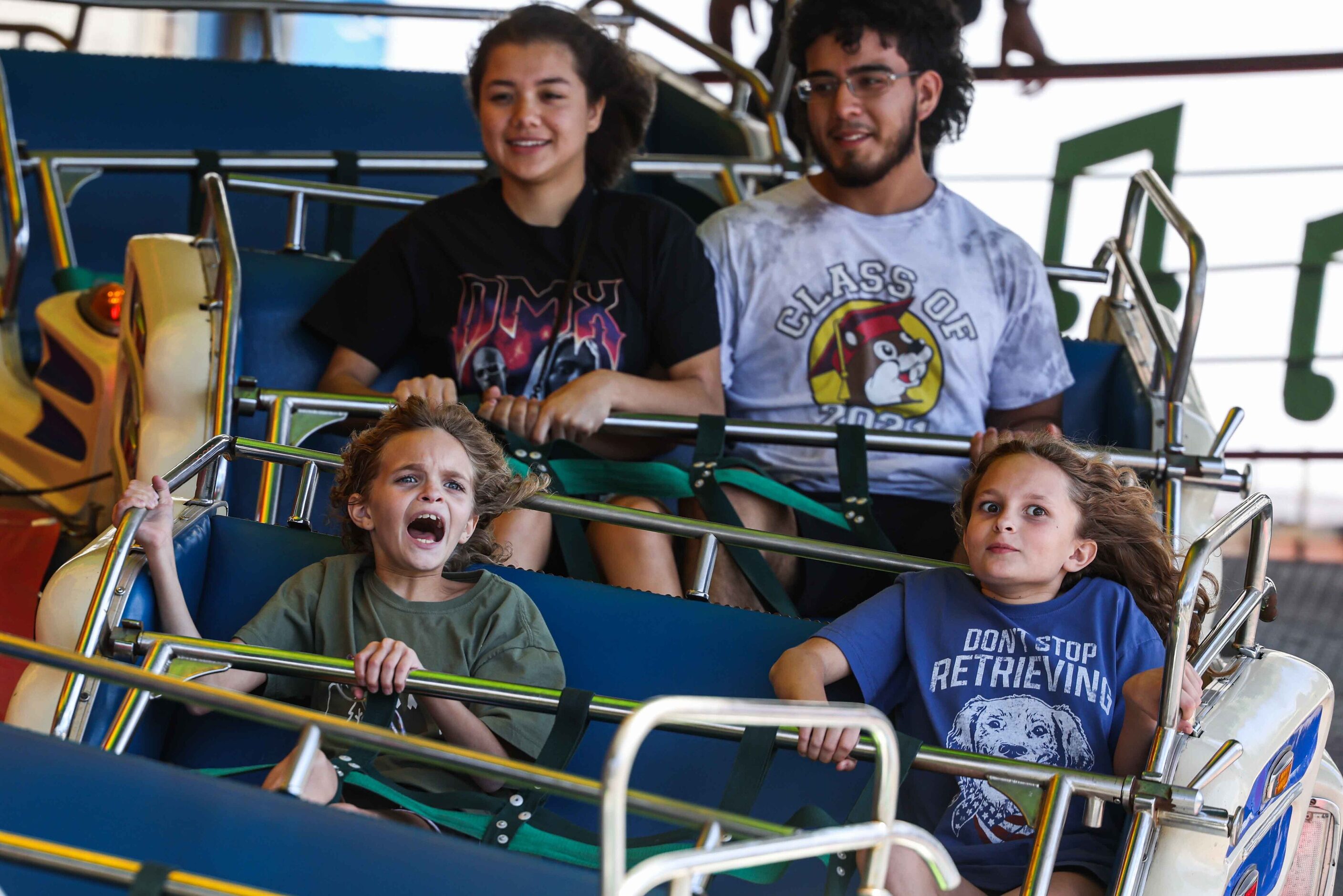 People  aboard a carnival ride at the State Fair of Texas during its opening day in Dallas...