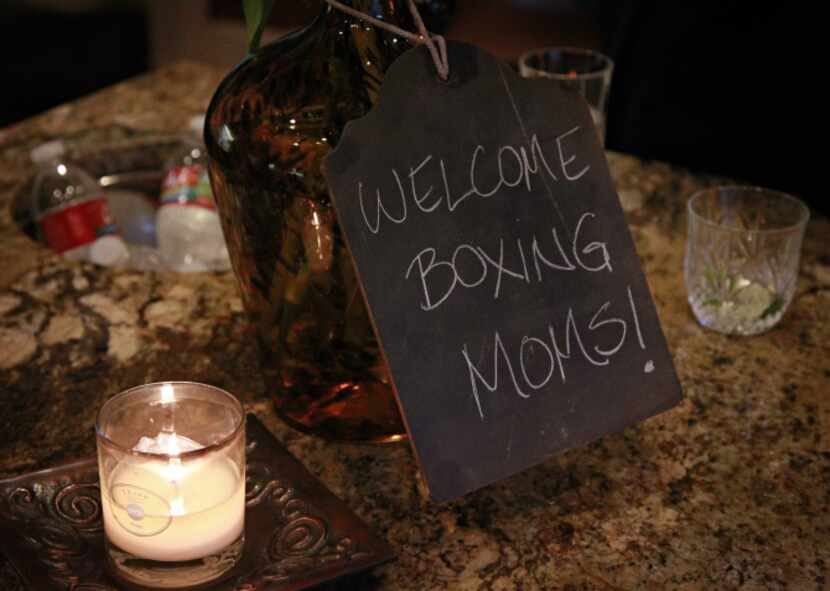 A hand-written chalkboard sign welcomes attendees to a "boxing club" get-together Tuesday,...