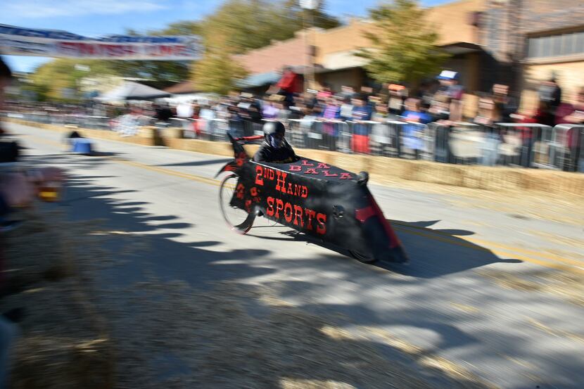 Coffin racers cross the finish line during the Day of the Dead Festival near East Hickory...