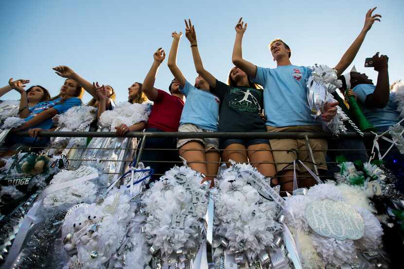 Mansfield Lake Ridge High School students sang their school song above homecoming mums...