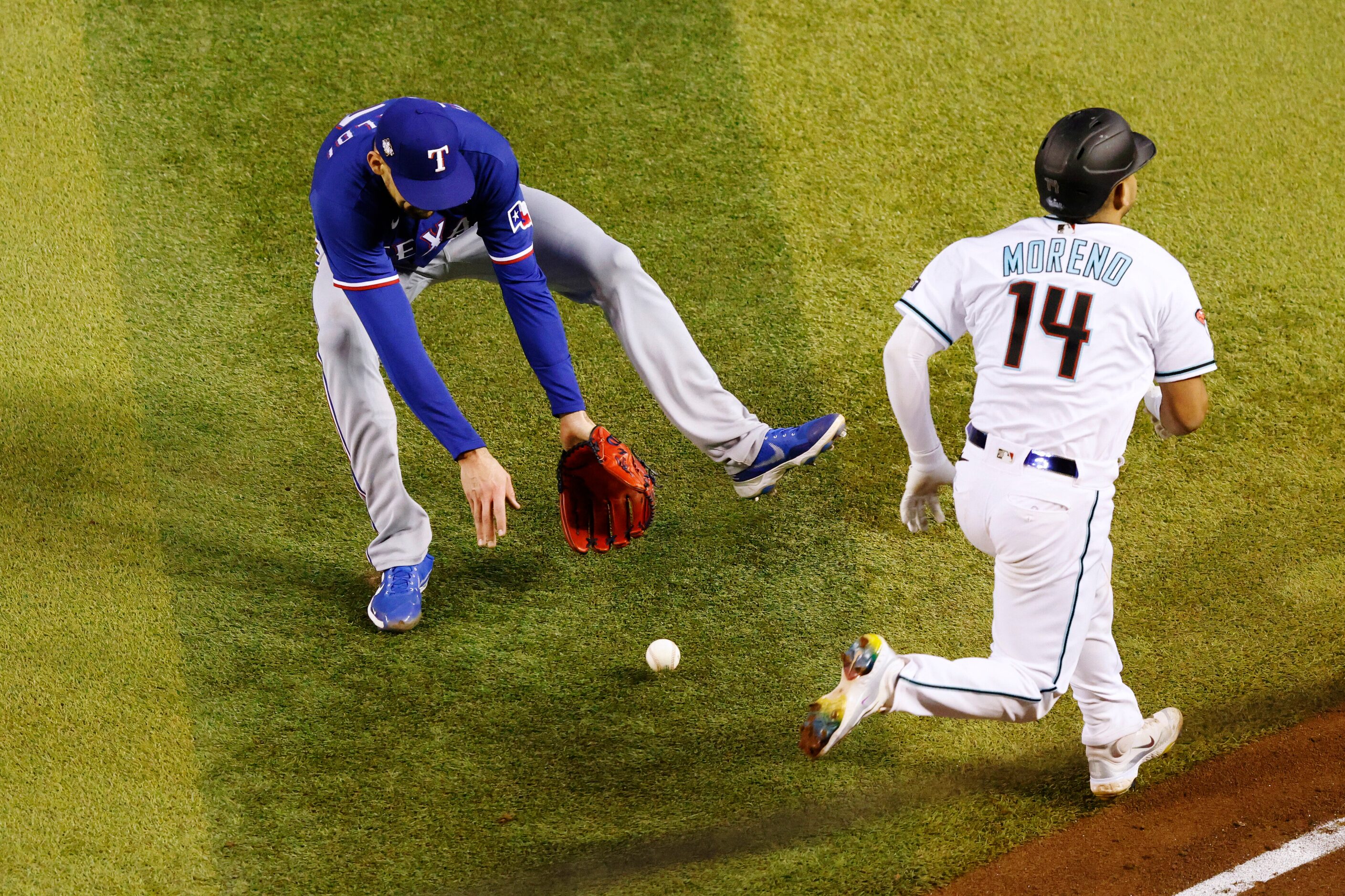 Texas Rangers starting pitcher Nathan Eovaldi (17) fields a hit by Arizona Diamondbacks’...