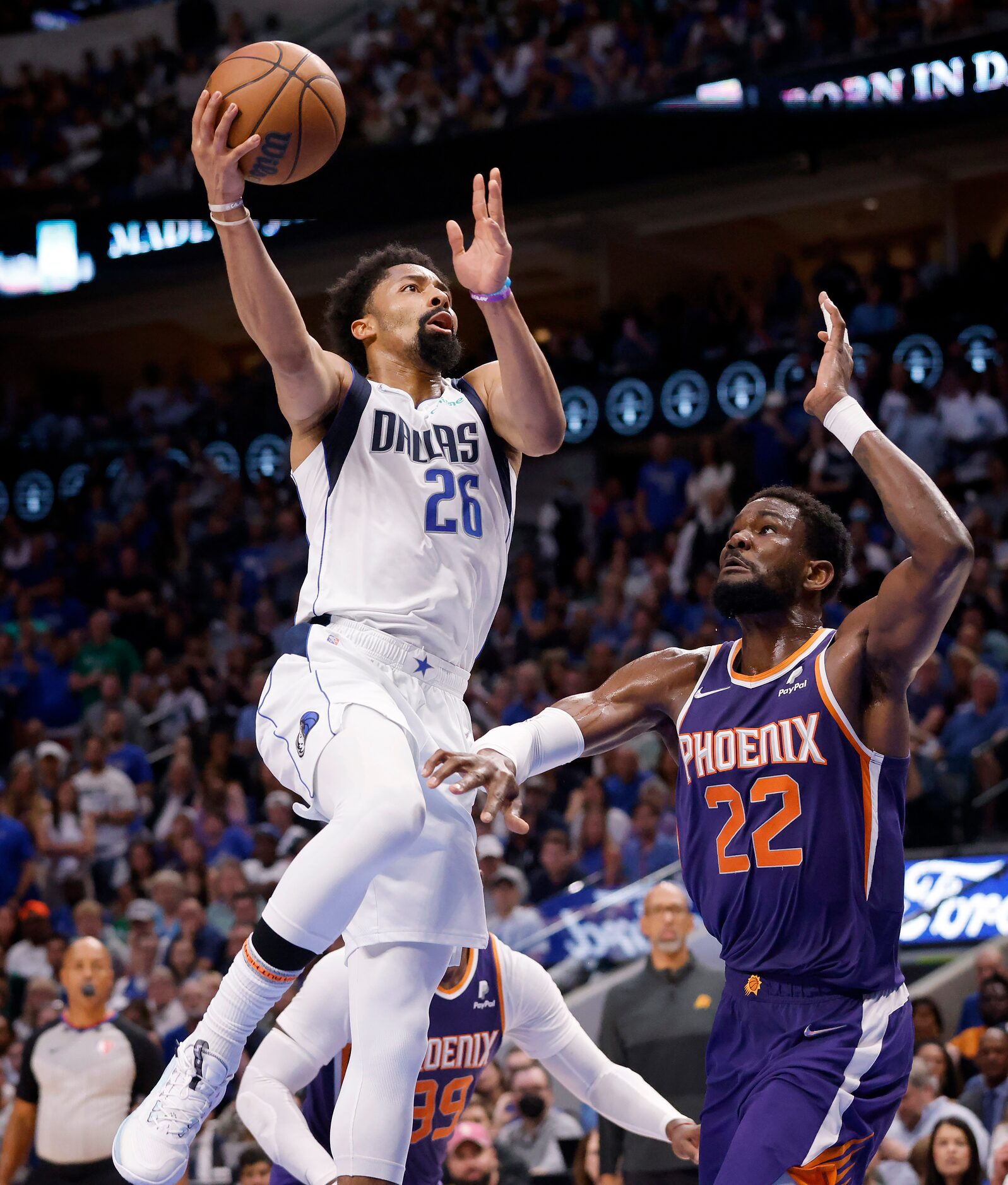 Dallas Mavericks guard Spencer Dinwiddie (26) layering s up a shot over Phoenix Suns center...