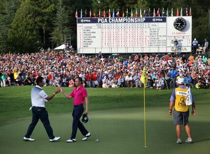 Justin Thomas, right, and Hideki Matsuyama of Japan, finish the 18th hole during the final...