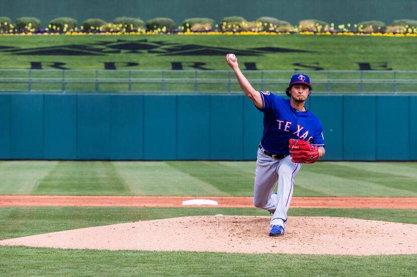 Texas Rangers starting pitcher Yu Darvish (11) pitches during the first inning of a spring...