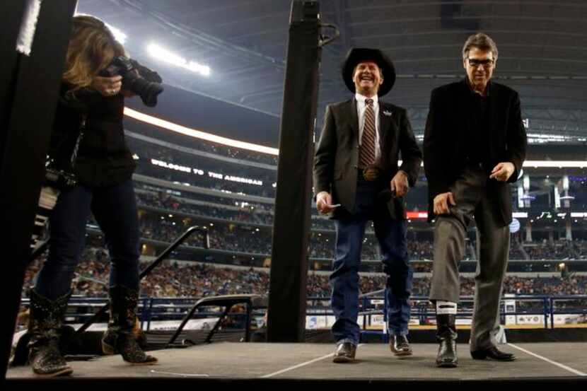 
Dave Appleton shares a laugh with Governor Rick Perry as he shows his cowboy boots during...