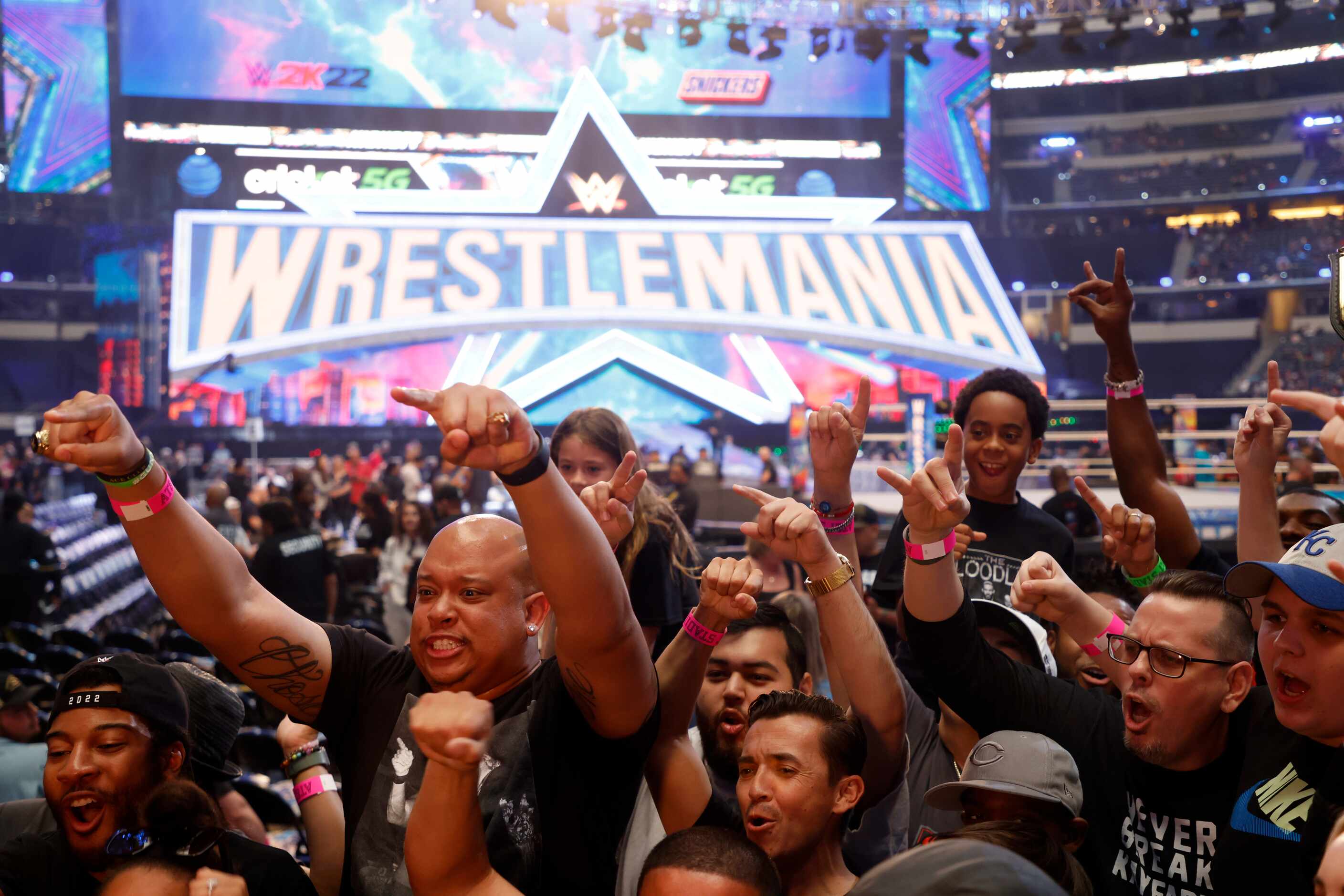 Van Robbins, left, of San Antonio, and other fans cheer for TV camera prior to WrestleMania...