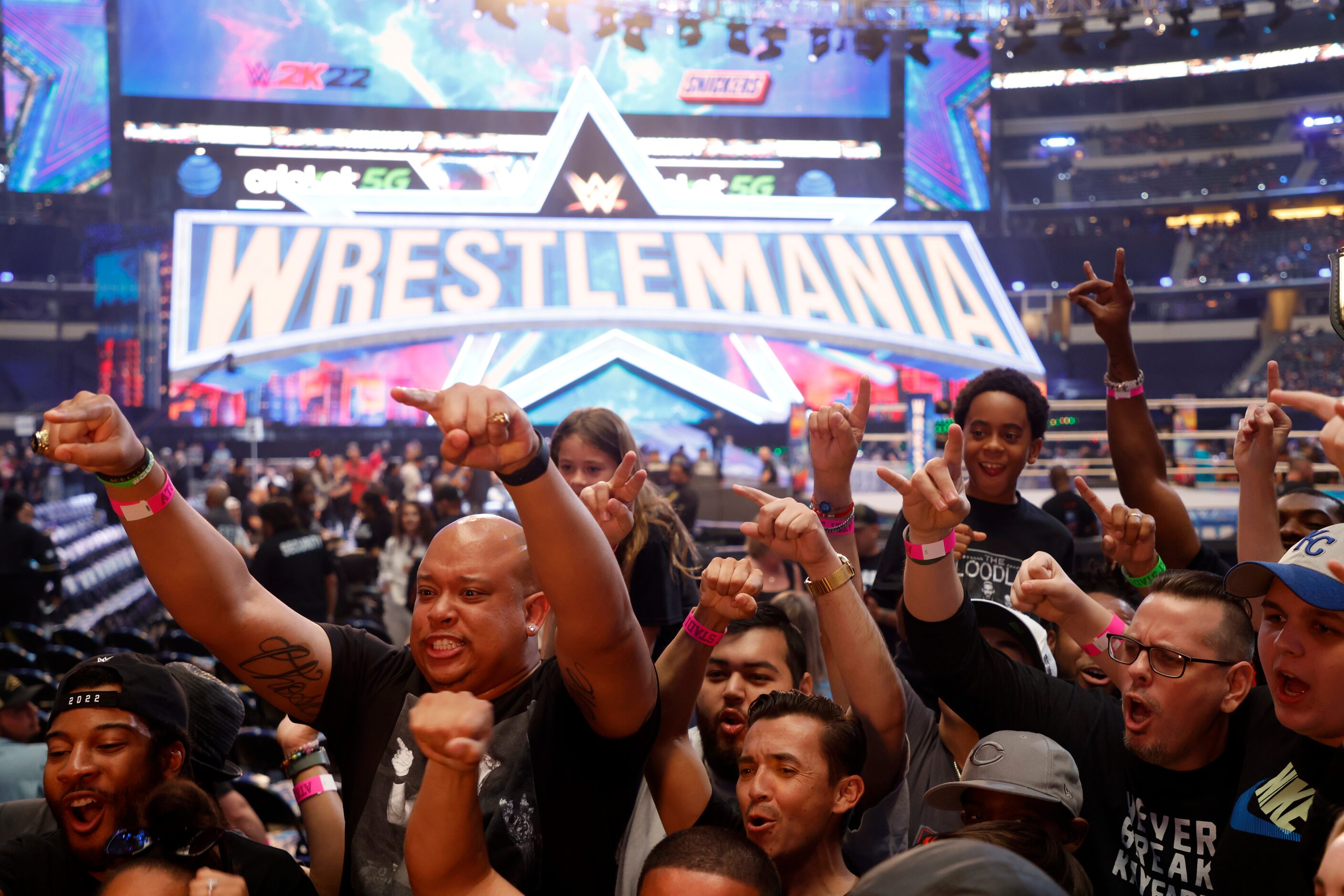 Van Robbins, left, of San Antonio, and other fans cheer for TV camera prior to WrestleMania...