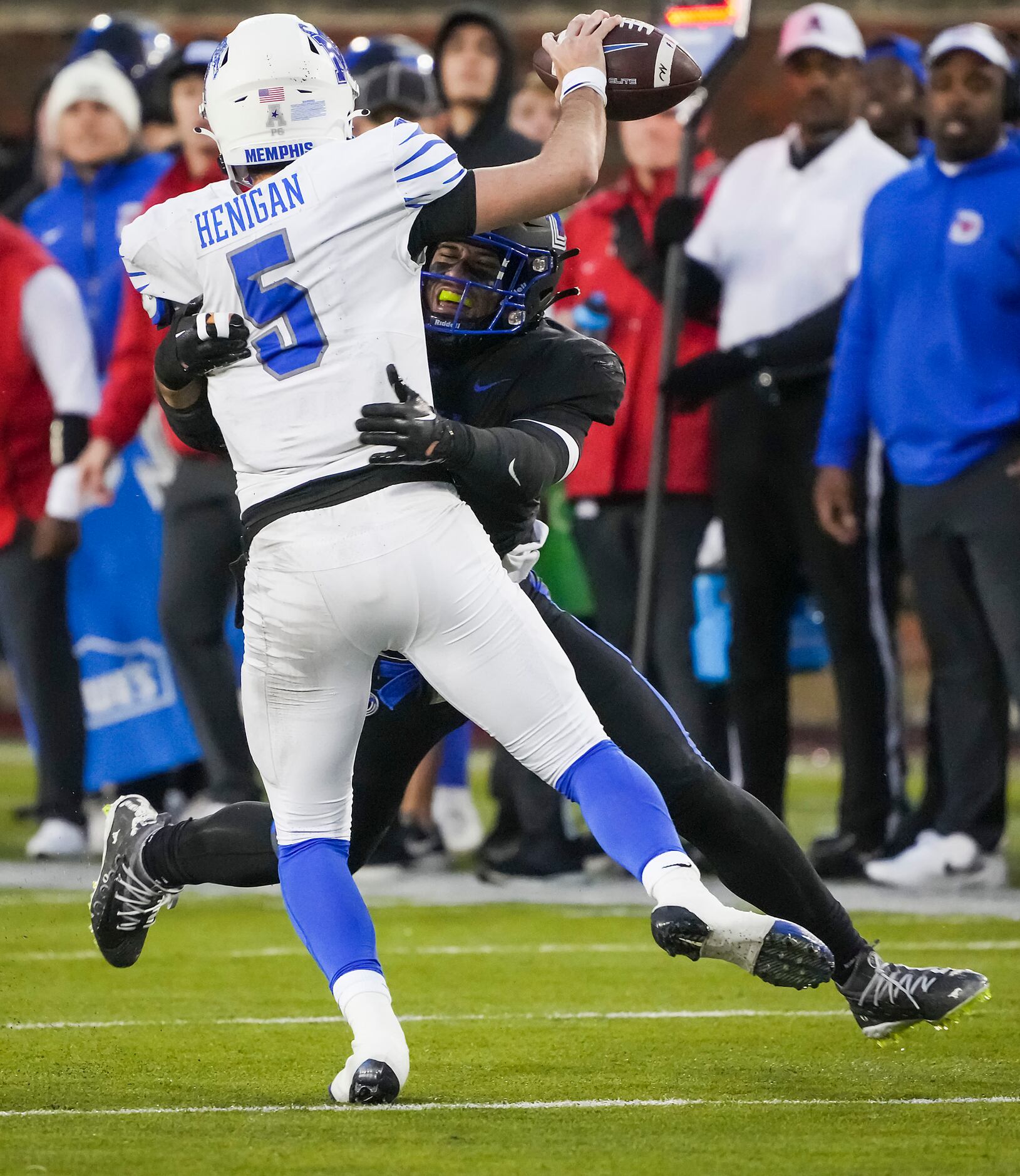 Memphis quarterback Seth Henigan (5) tries to pass as he is hit by SMU linebacker Isaac...