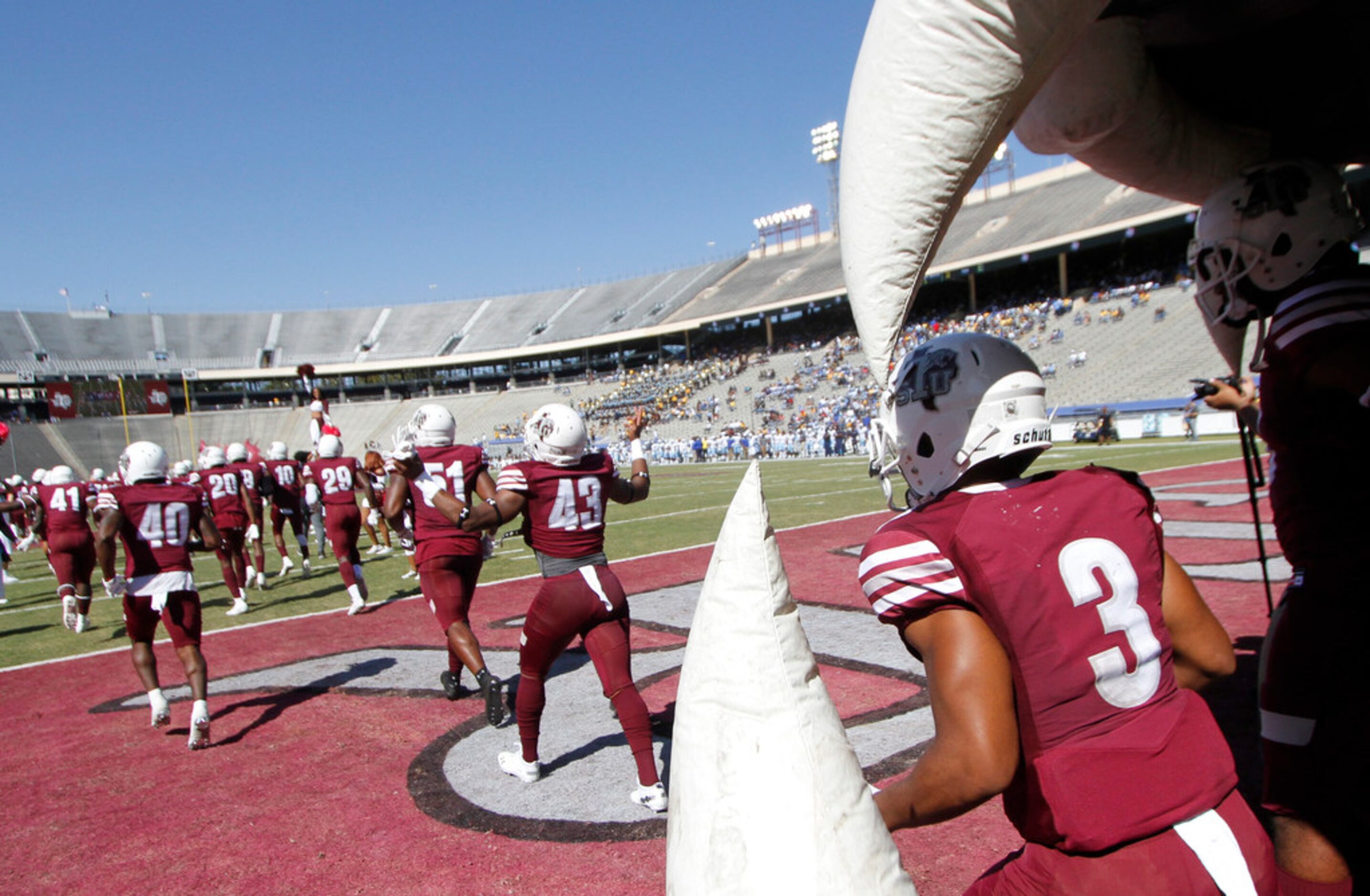 Members of the Texas Southern Tigers emerge from the team's inflatable  before the opening...