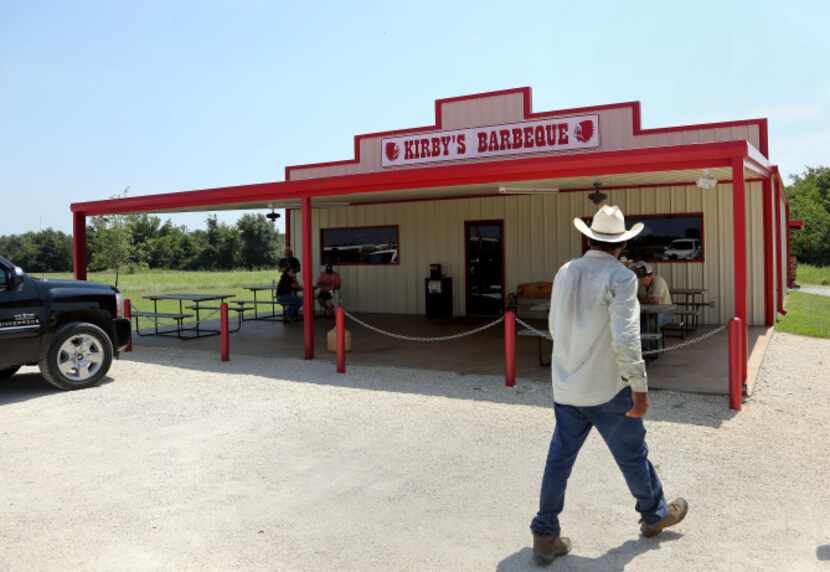 A diner walks to Kirby's Barbeque in Mexia, Texas, on August 2, 2013 during the Posse's...