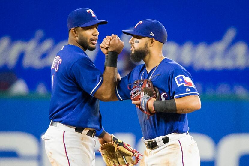 Texas Rangers shortstop Elvis Andrus (1) and second baseman Rougned Odor celebrate after a...