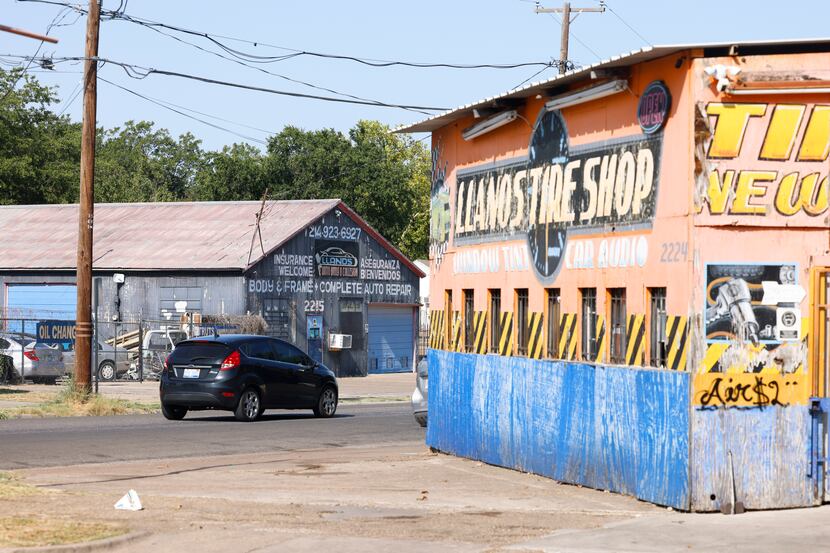 Traffic passes along along West Clarendon Drive overlooking tire shops in west Oak Cliff on ...