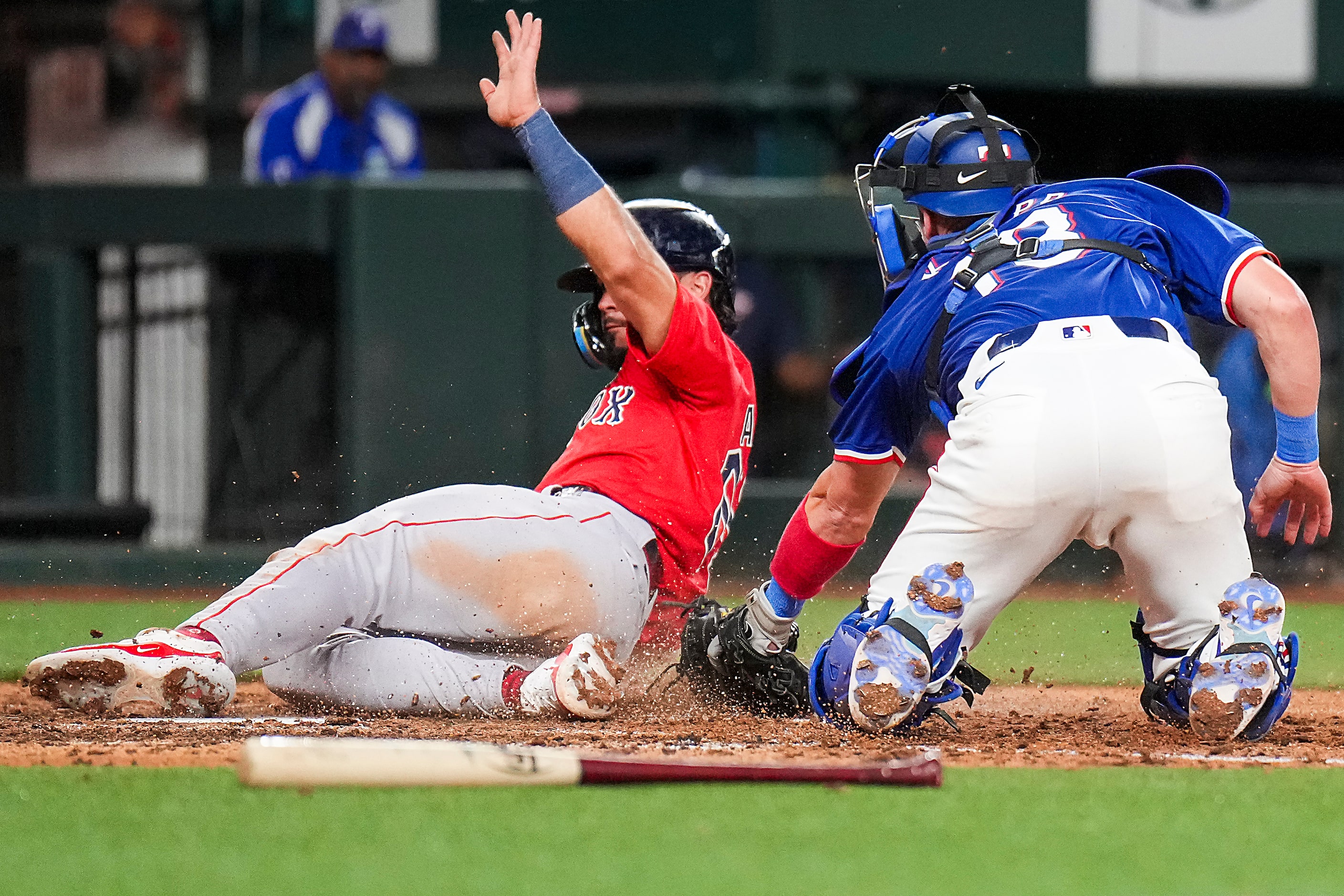 Eddy Alvarez of the Boston Red Sox scores from third base on a fielders choice ahead of the...