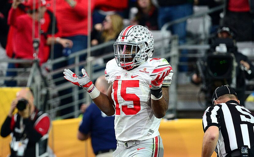  Running back Ezekiel Elliott #15 of the Ohio State Buckeyes celebrates his fourth touchdown...