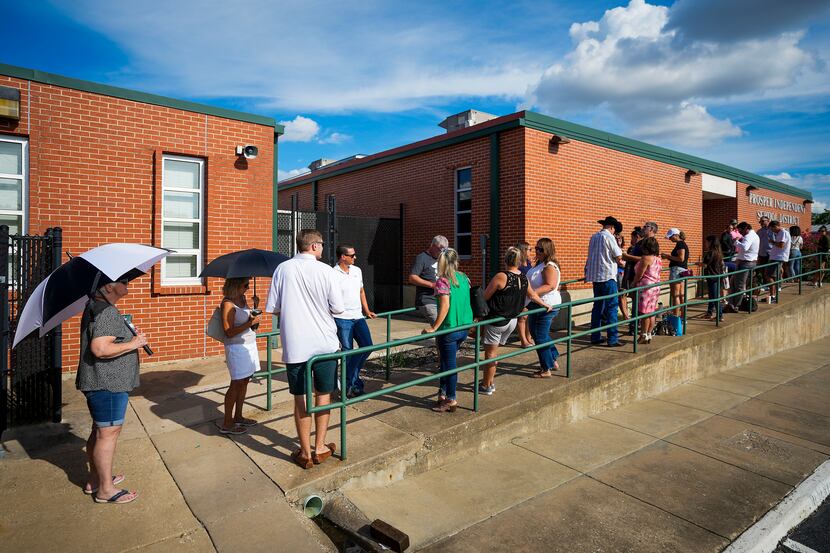 People stand in line to enter a Prosper ISD board meeting on Monday, Aug. 29, 2022, in...