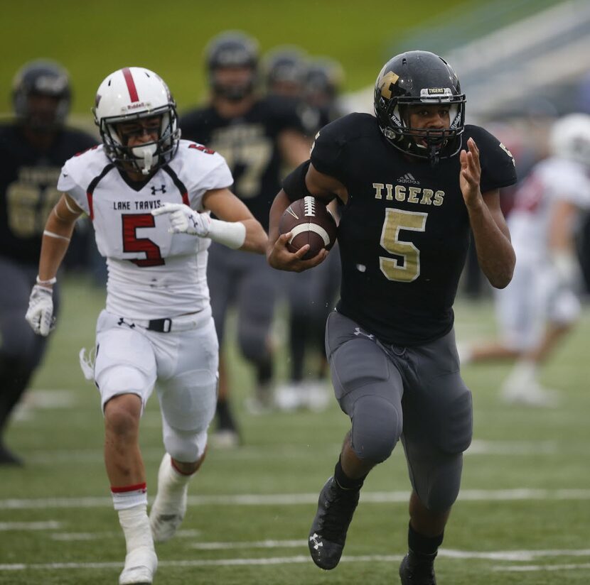 Mansfield Tigers Kennedy Brooks (5) escape from Lake Travis Cavaliers Robert Lee Rayos (5) ...