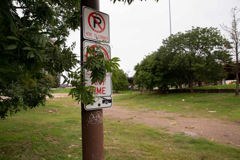 "No parking" signs are still affixed to now-random light poles that once stood alongside...