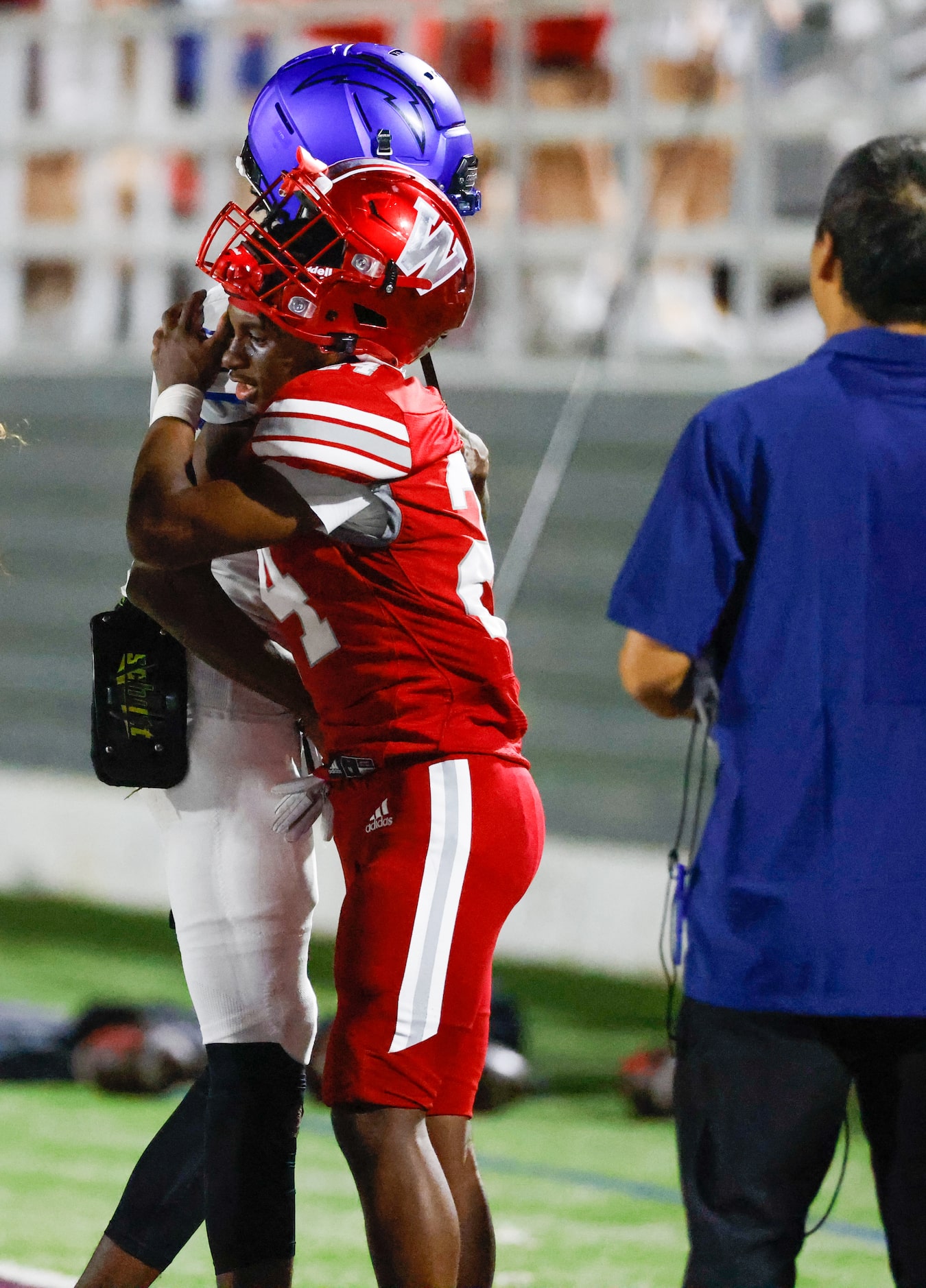 Conrad quarterback Ladavian Frost-Harris (8) embraces Woodrow Wilson defensive back Jaylen...