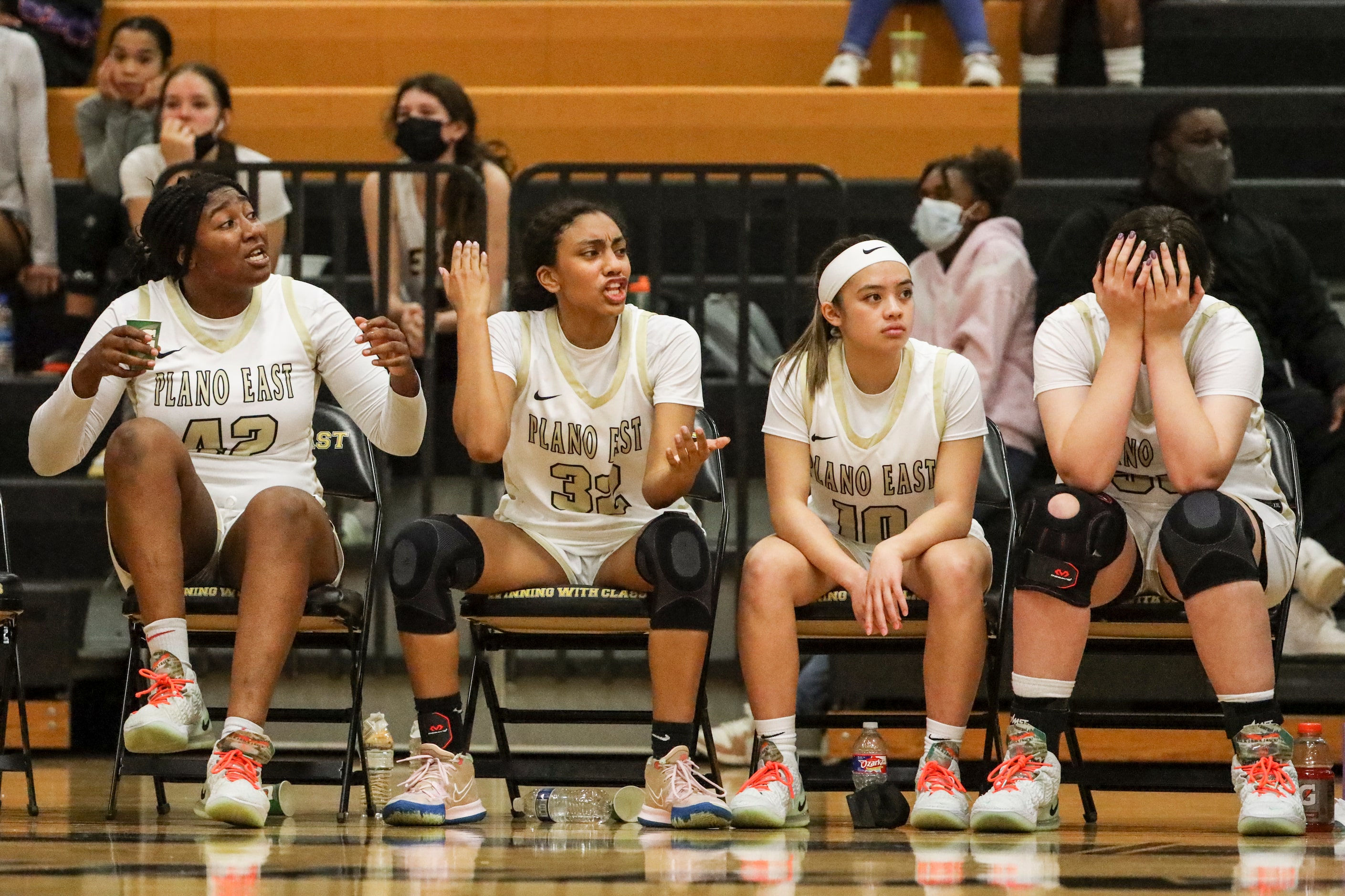 The Plano East High School woman’s basketball team bench reacts to the play in the fourth...