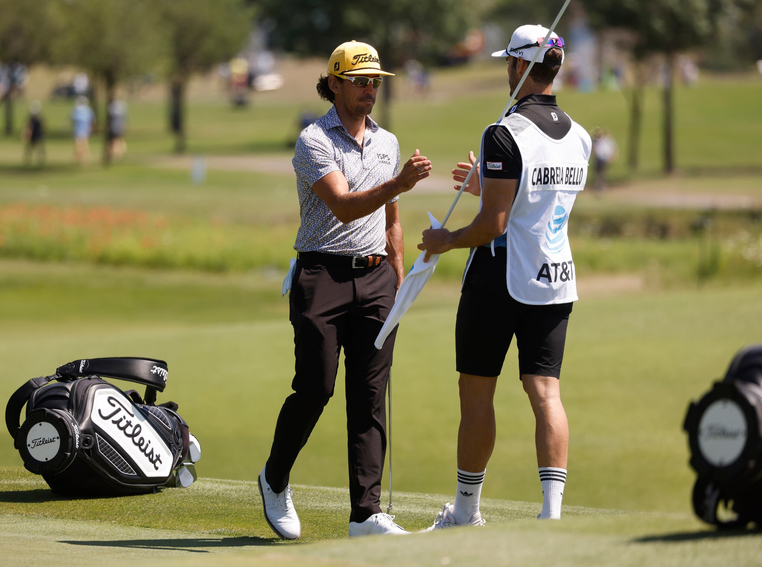 Rafa Cabrera Bello with his caddie after finishing up the day -8 on the 9th hole during...