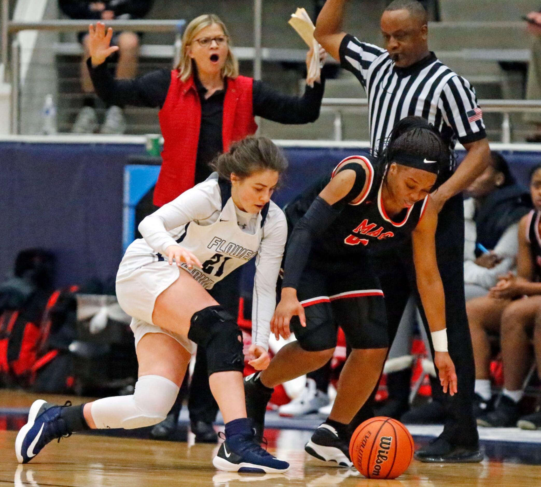 Flower Mound High School guard Paulina Porter (21) is fouled by Irving MacArthur High School...