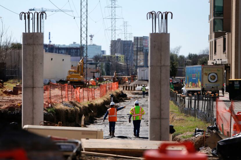 Workers construct on the site of the Katy Trail Bridge on Mockingbird Lane in Dallas on...