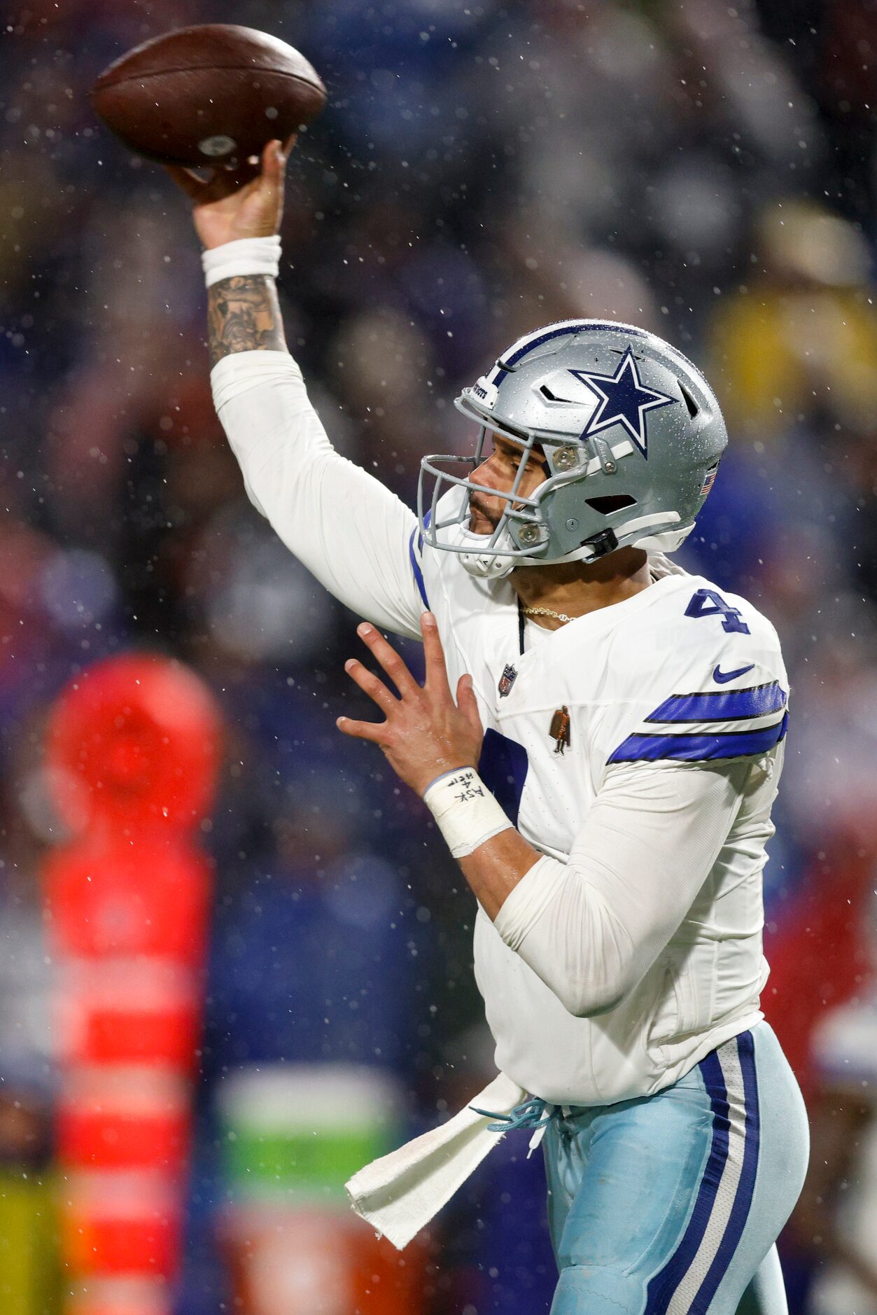 Dallas Cowboys quarterback Dak Prescott (4) throws a pass in the rain during the second half...