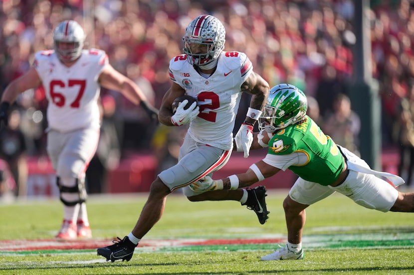 Ohio State wide receiver Emeka Egbuka (2) carries the ball against Oregon defensive back...