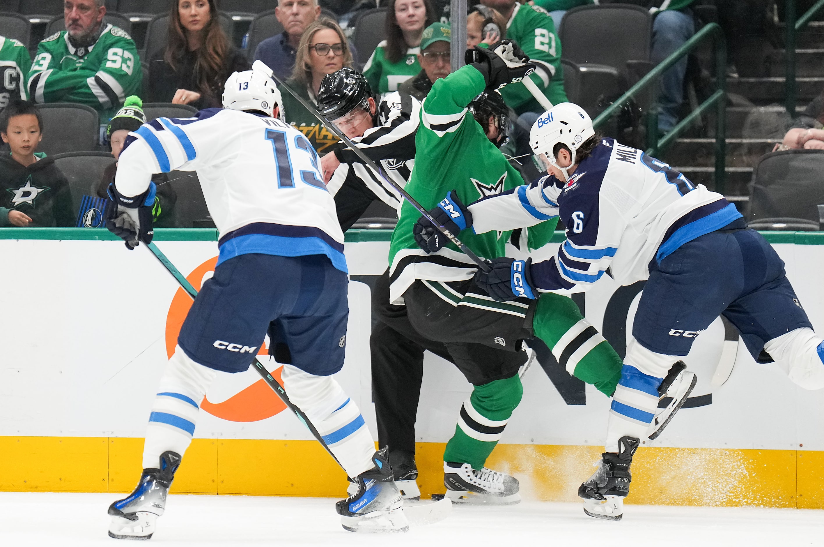 Linesman Steve Barton (59) tries to avoid Dallas Stars center Matt Duchene (95) and Winnipeg...