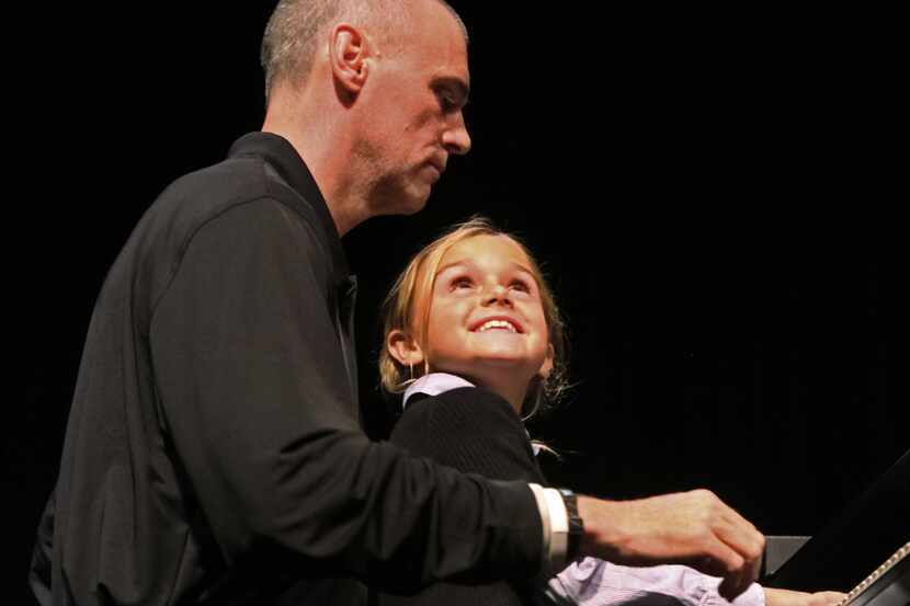 Dallas Mavericks' head coack Rick Carlisle plays piano with his daughter Abby Carlisle at...