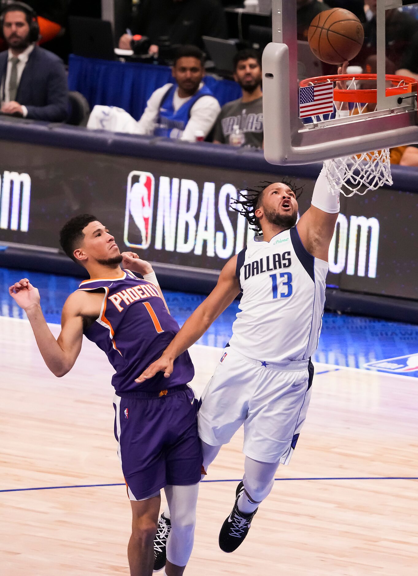 Dallas Mavericks guard Jalen Brunson (13) scores past Phoenix Suns guard Devin Booker (1)...