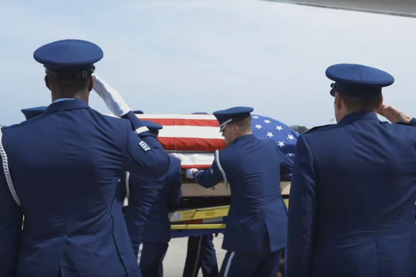 Air Force personnel transport the remains of Col. Roy Knight, Jr., who was shot down over...