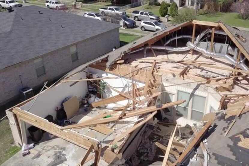 The roof of this home in Mesquite was torn off and the property destroyed after a tornado...