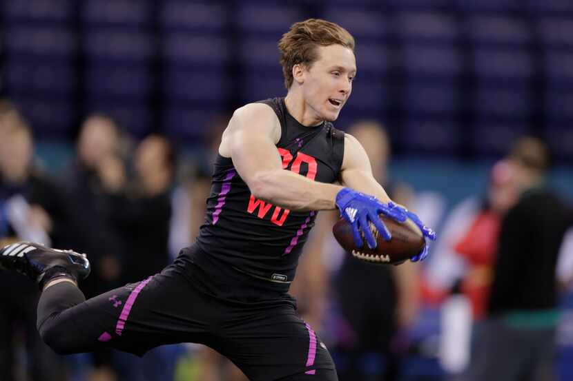 SMU wide receiver Trey Quinn runs a drill at the NFL football scouting combine in...