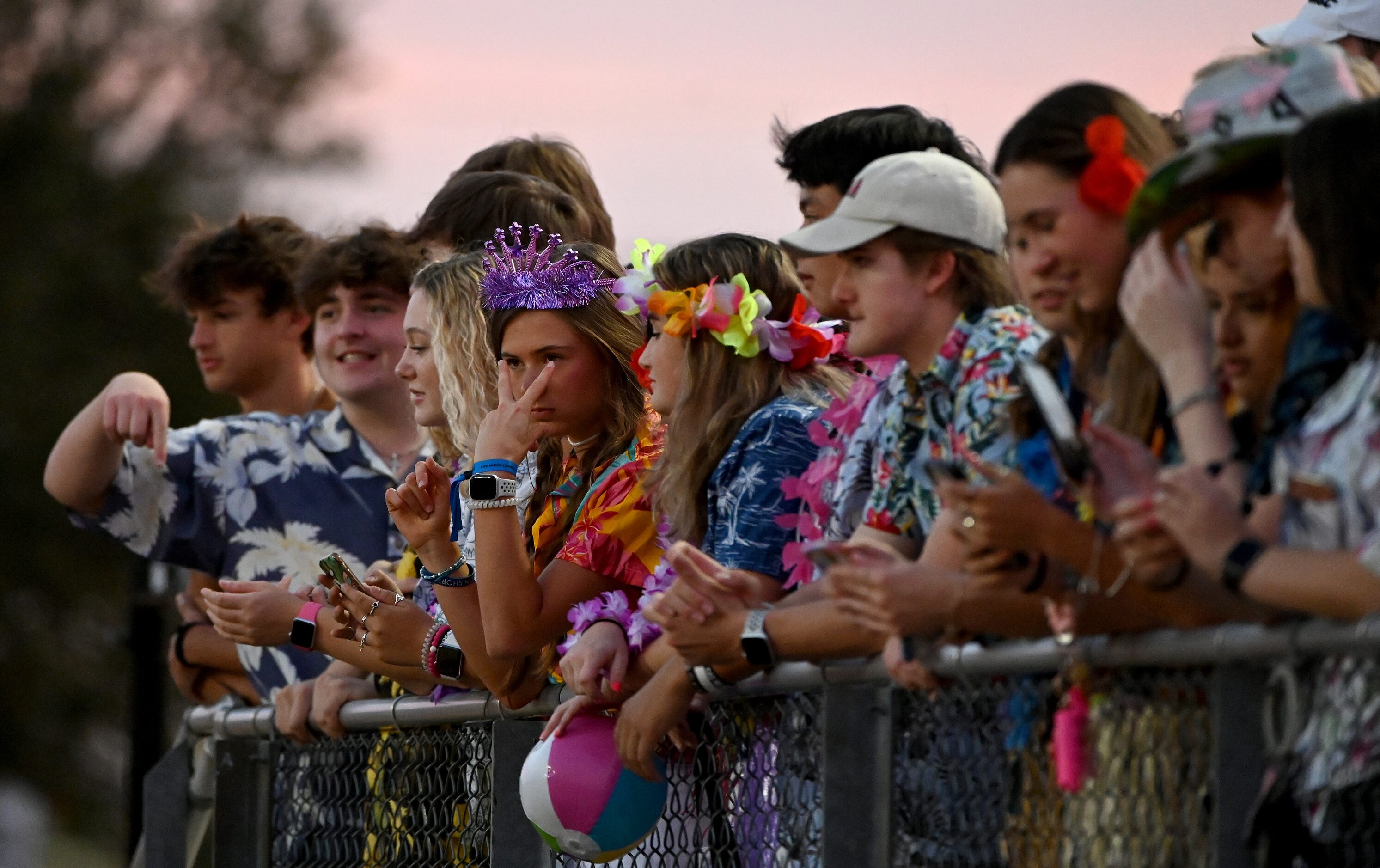 John Paul II students watch the first half of a high school football game between John Paul...