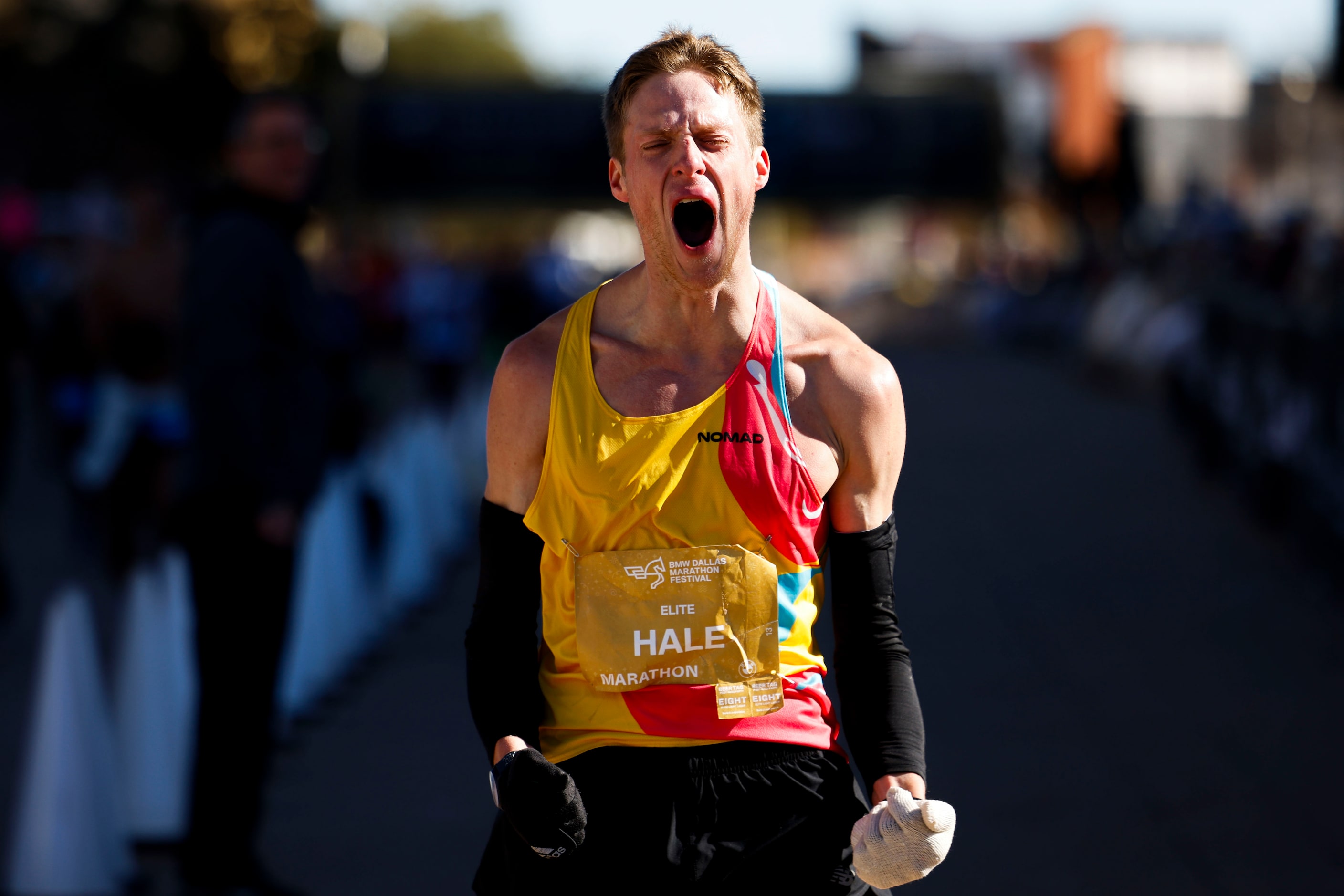 Men’s marathon finisher Joseph Hale, 30, of Grapevine, celebrates after reaching the finish...