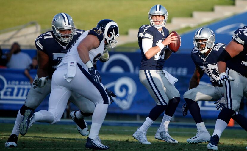 Dallas Cowboys quarterback Kellen Moore (17) looks for an open receiver during the first...