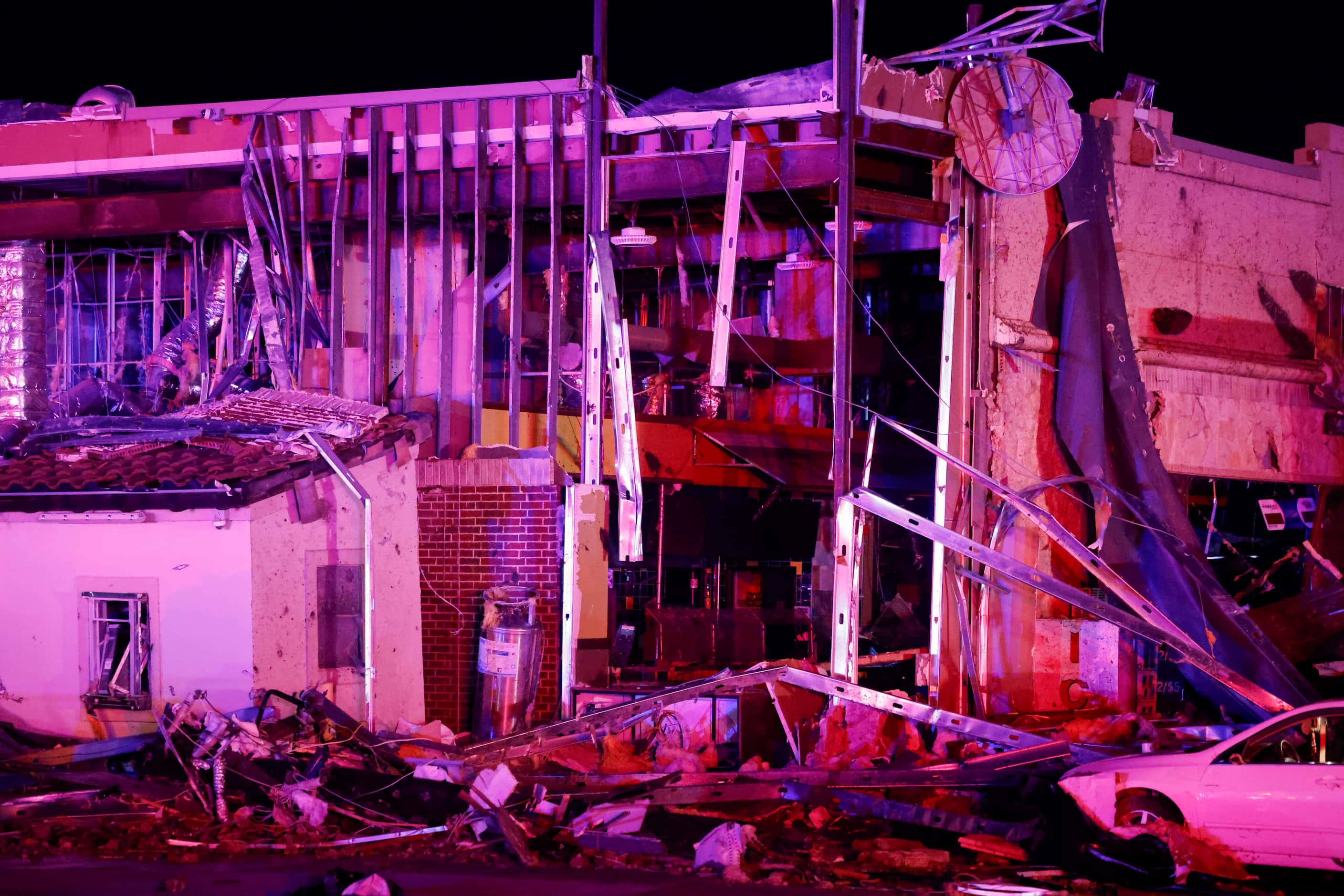 Metal framing is visible at a heavily damaged Shell gas station after a suspected tornado...
