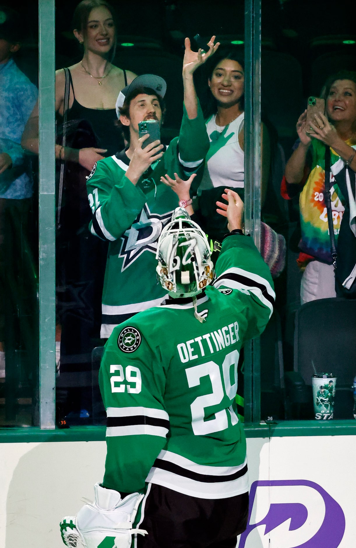 Dallas Stars goaltender Jake Oettinger (29) flips the puck to a fan after it was announced...