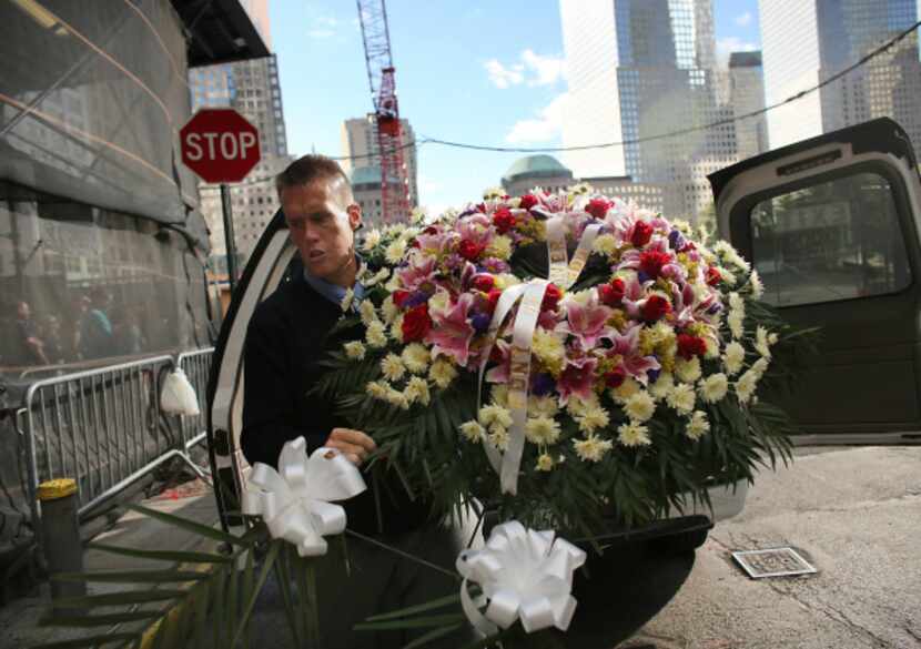 Firefighter John Manning delivered a wreath Monday to Engine Company 10 across from Ground...