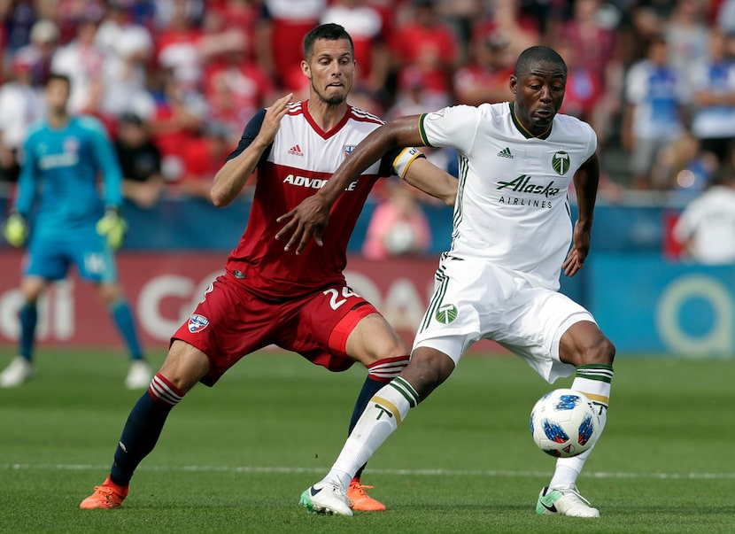 FC Dallas defender Matt Hedges (24) and Portland Timbers forward Fanendo Adi (9) chase to...