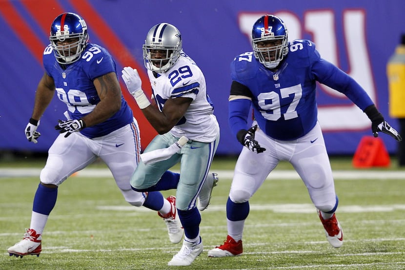 Dallas Cowboys running back DeMarco Murray (29) escapes the New York Giants defensive tackle...
