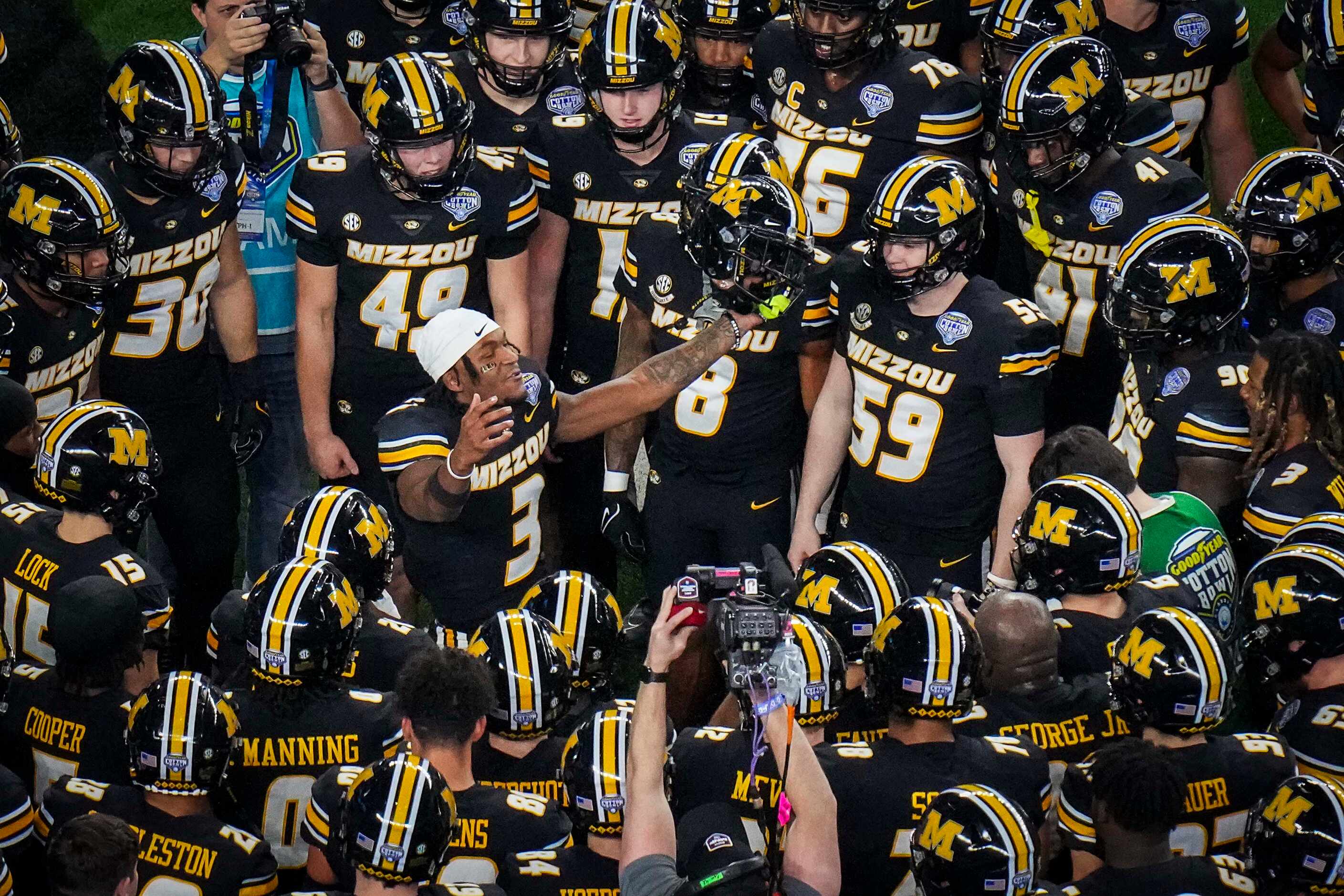 Missouri players huddle around wide receiver Luther Burden III (3) before the Goodyear...