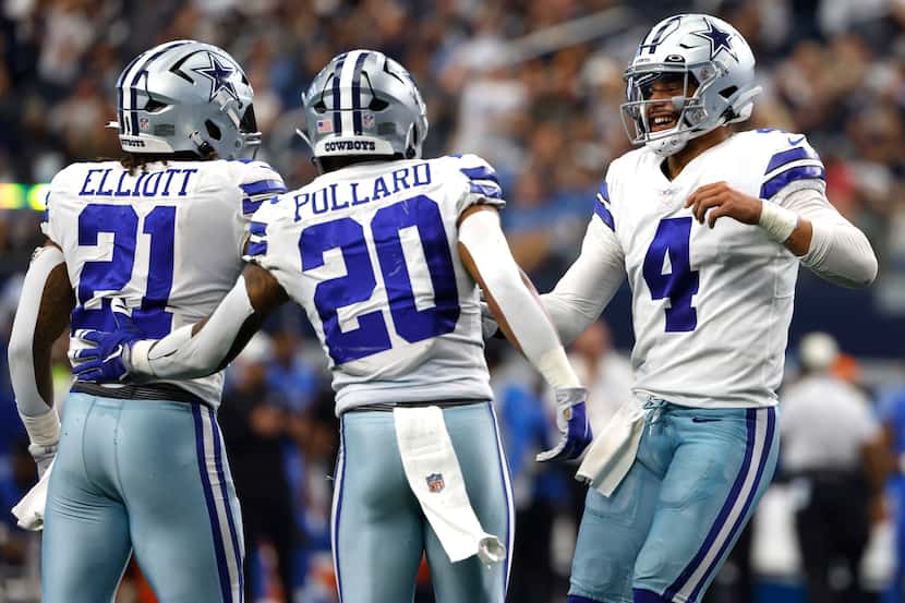 Dallas Cowboys quarterback Dak Prescott (4) celebrates the team's win with running backs...