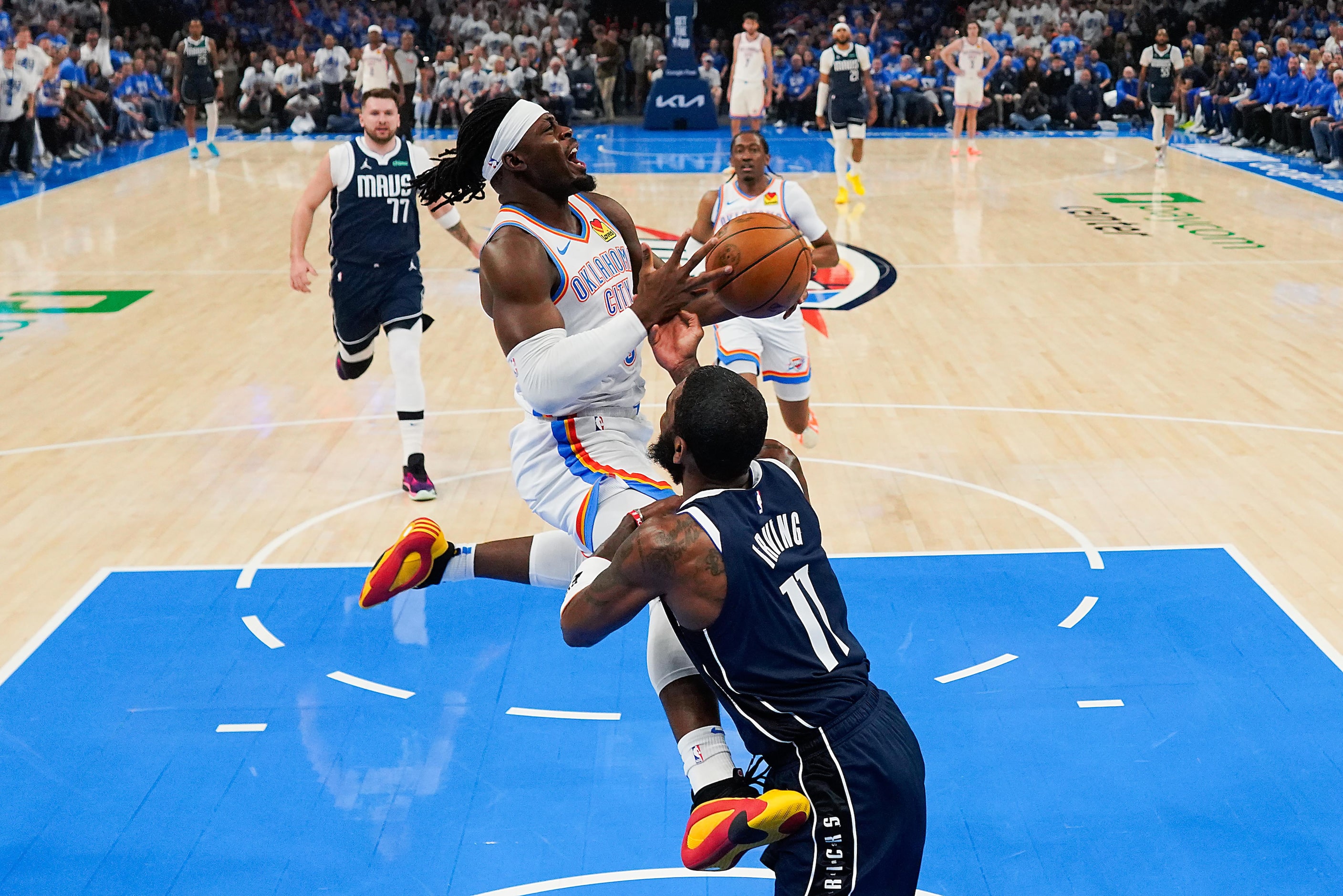 Oklahoma City Thunder guard Luguentz Dort (5) drives to the basket against Dallas Mavericks...