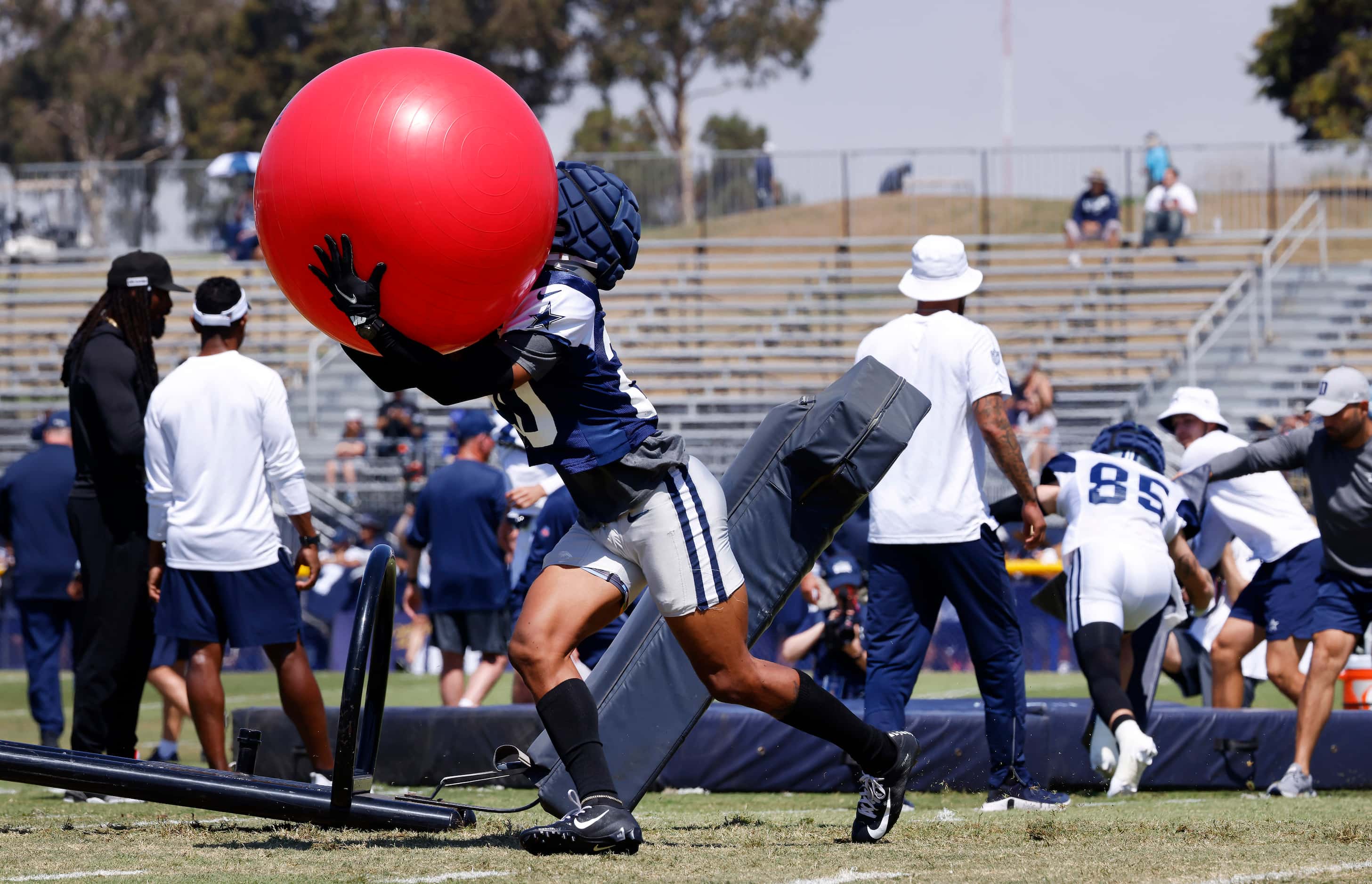 Dallas Cowboys defensive back Sheldrick Redwine (20) scoops up an exercise ball after...
