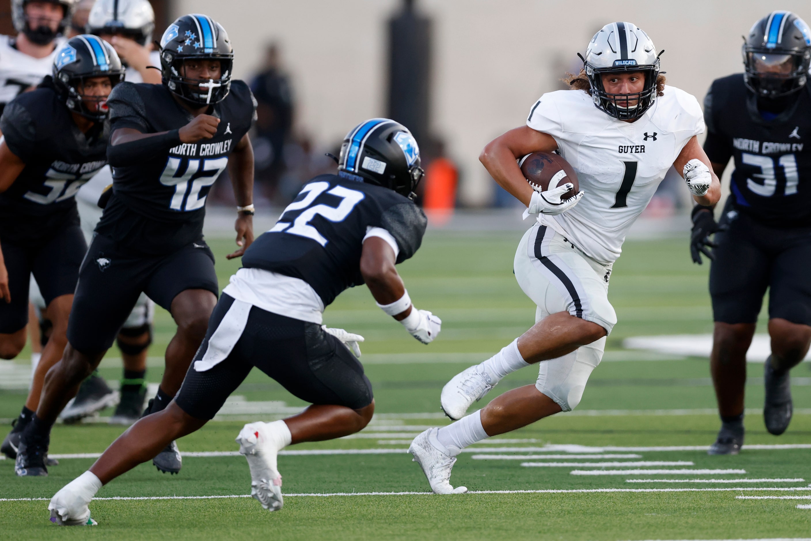 Denton Guyer running back Kaedyn Cobbs (1) runs away from North Crowley defensive back...